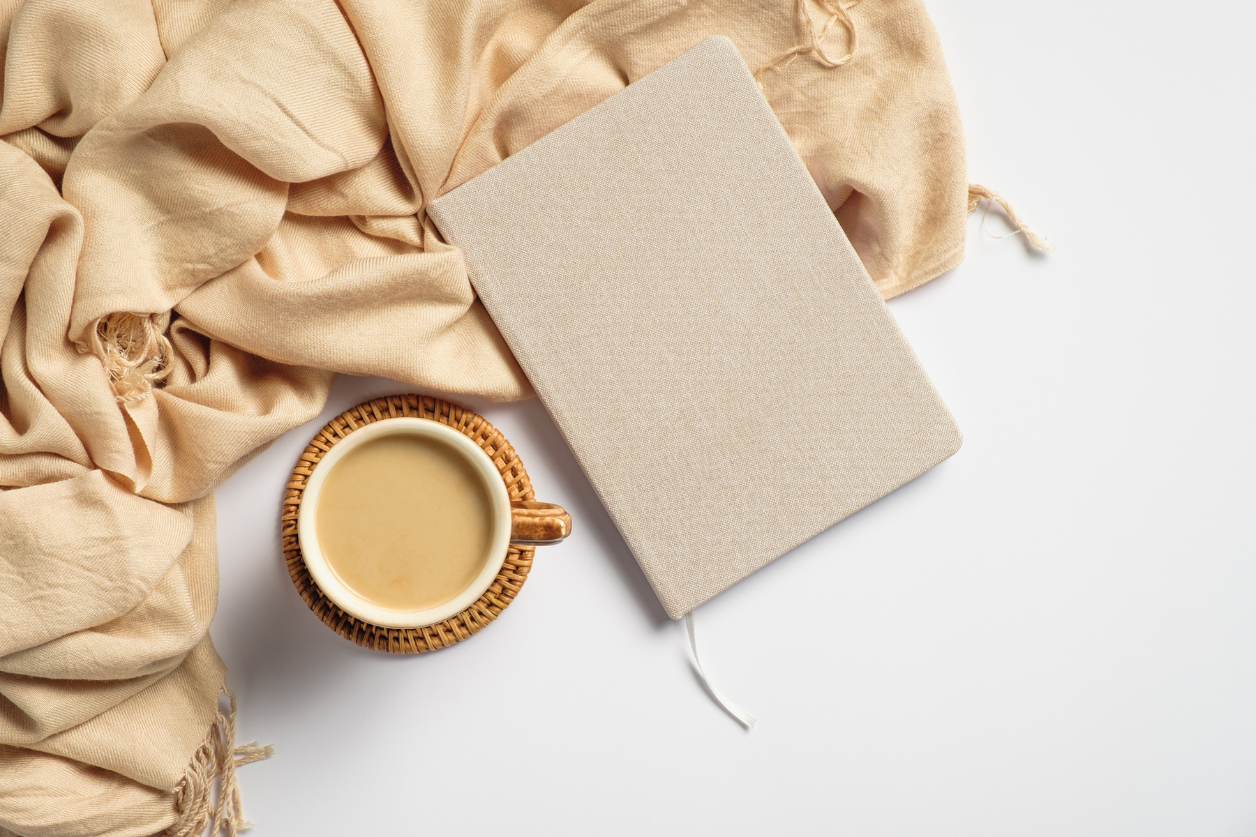 Modern Desk with Coffee Notebook and Scarf on White Background
