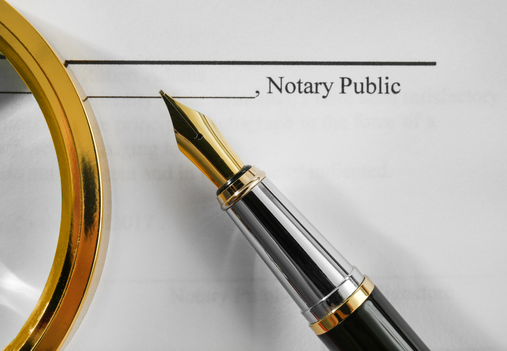 Notary Public Document with Magnifier and Fountain Pen
